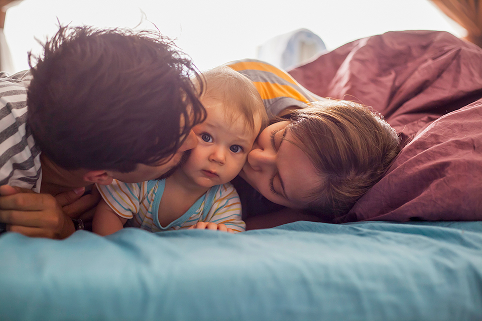 Adoptive Parents Kissing Baby